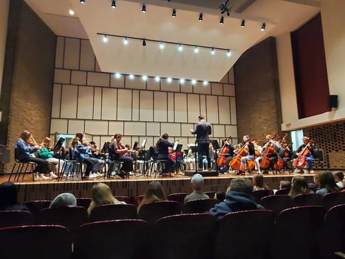 Students at Whitewater strings festival on stage.